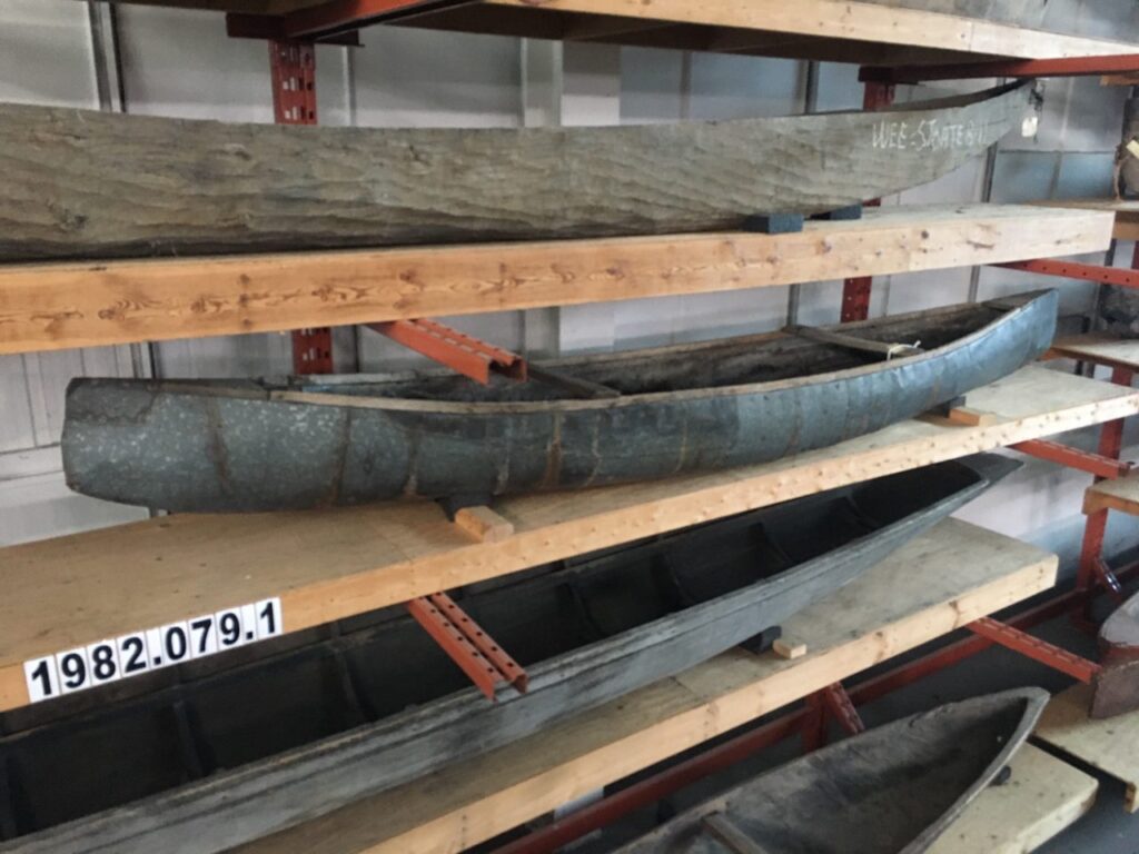 Shelves holding repaired dugout canoes