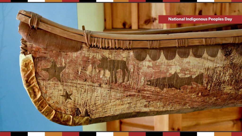 Close up of detailed artwork on a birch canoe