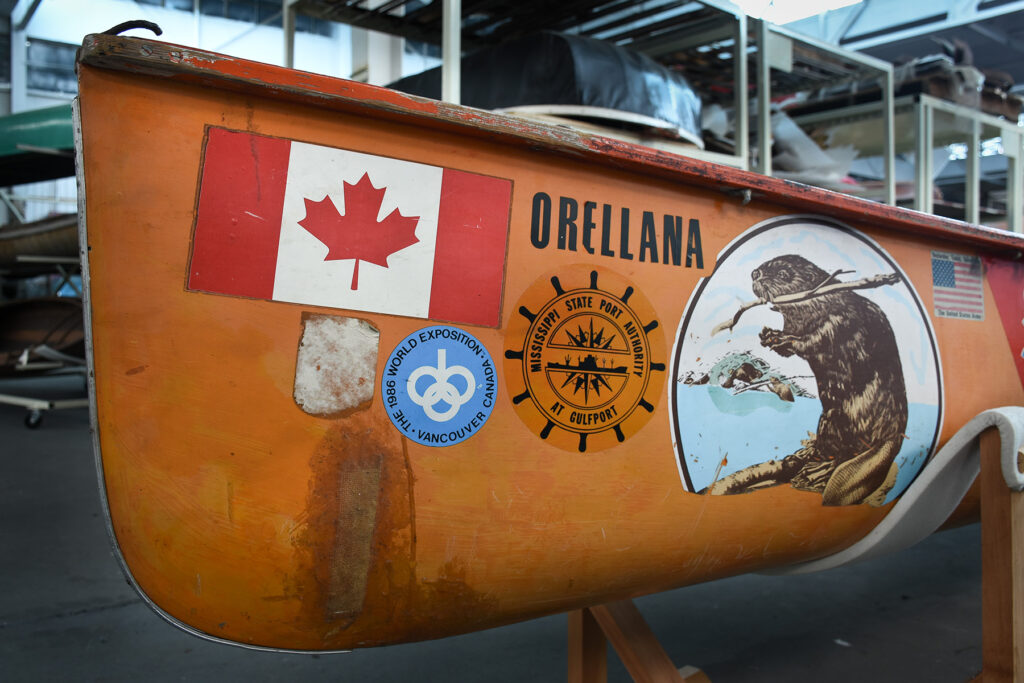 the Orellana, an orange fibreglass canoe covered in decals detailing its journey from Winnipeg, Manitoba to the Amazon.