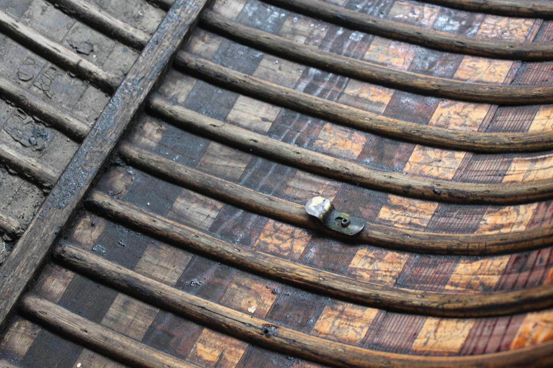 Close up shot of the inside of a canoe showing the details of the ribs