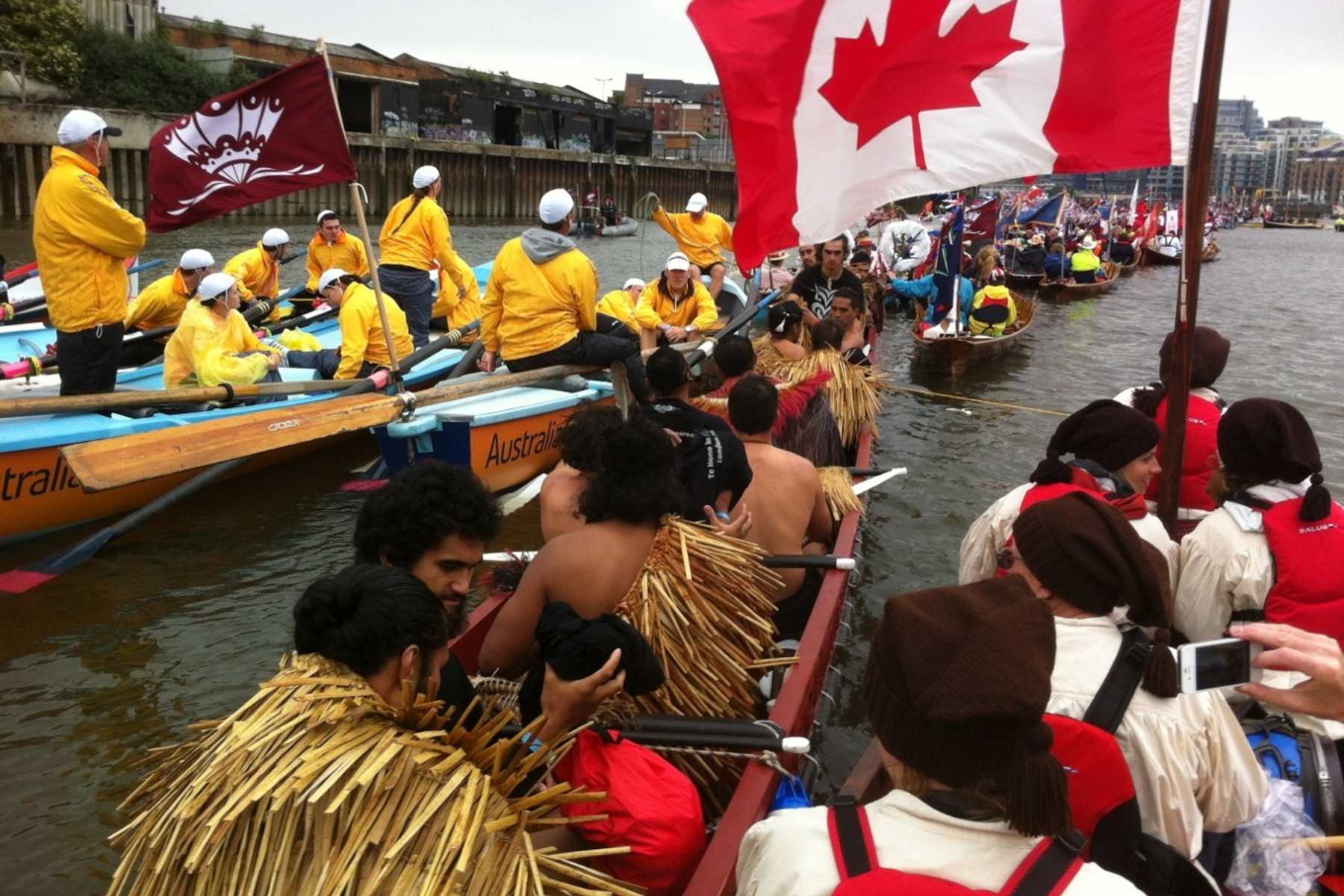 Several large canoes paddling in line