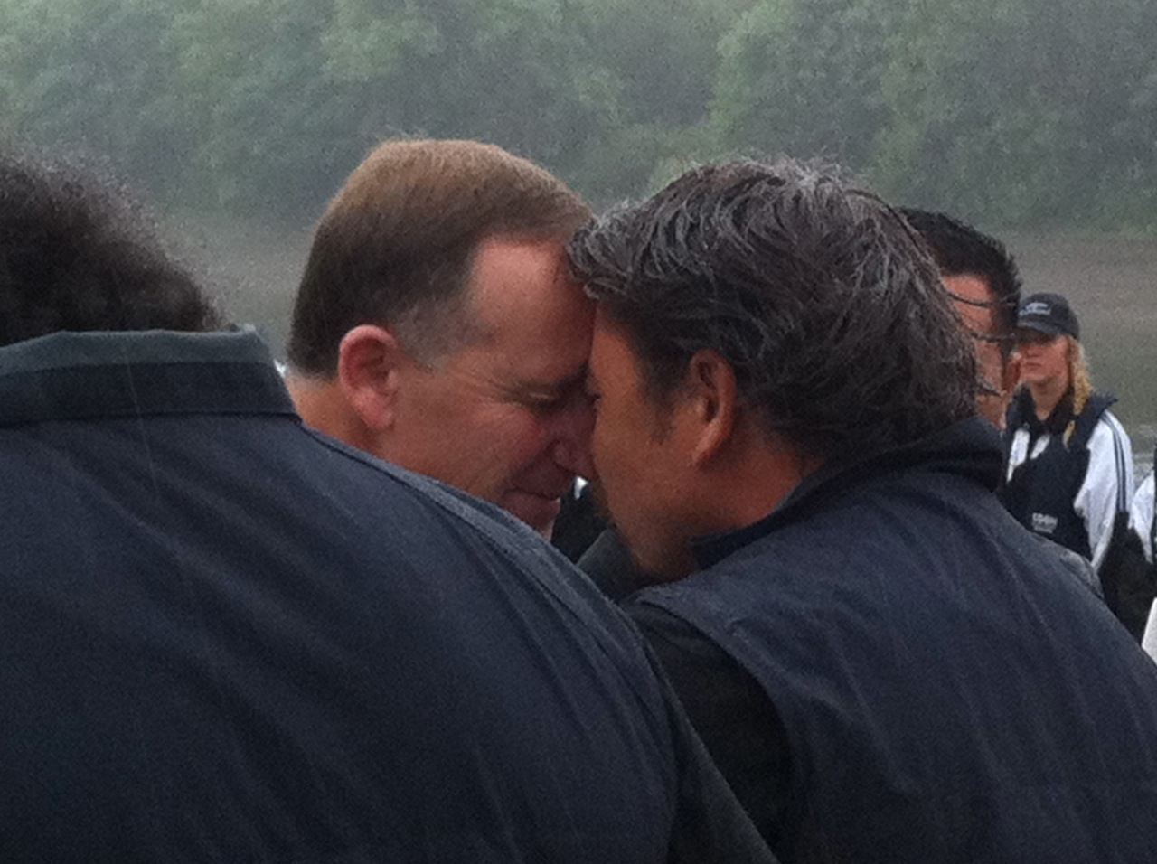 Two men give a traditional Maori “hongi” greeting