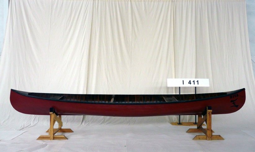 Longitudinal Strip Canoe "Diva" on display in front of white drop sheet