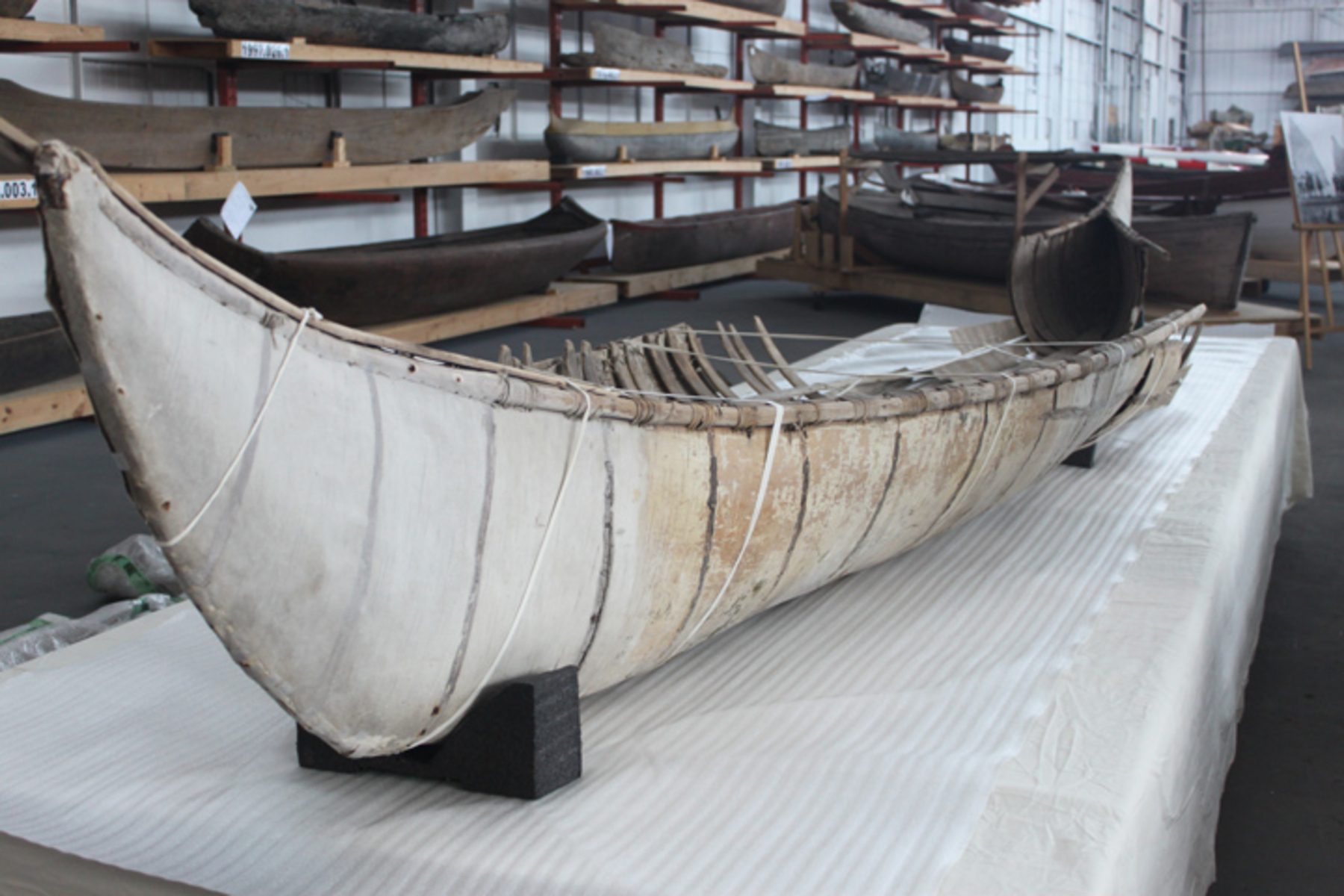 White canoe sits on a holder in the storage facility