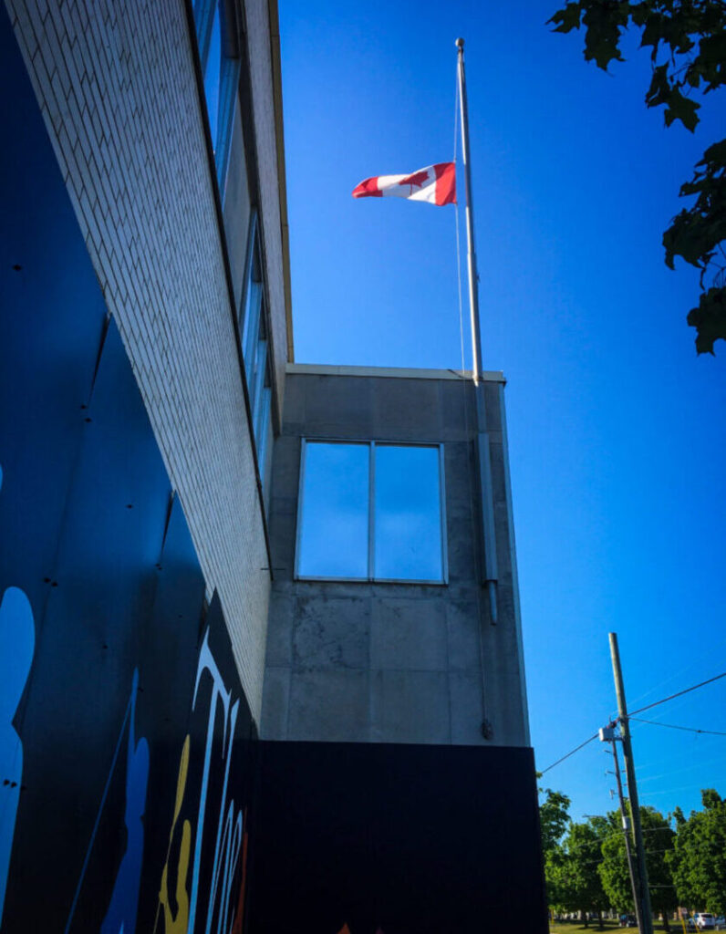 A Canadian flag flies at half mass