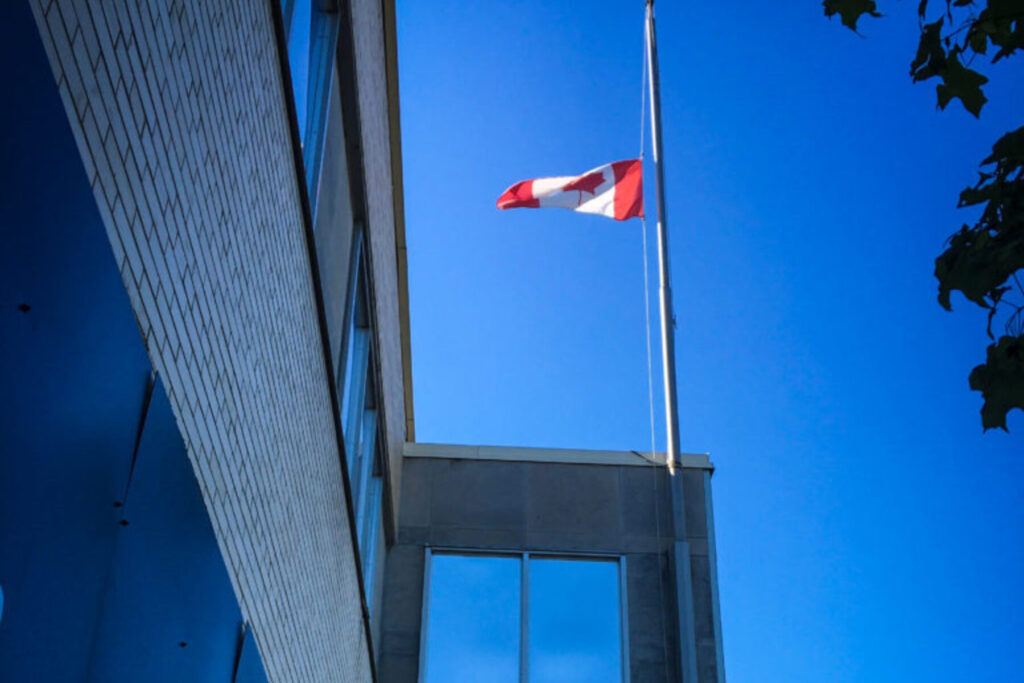 A Canadian flag flies at half mass