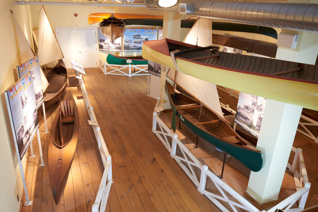 Aerial shot of an exhibit with colourful canoes.