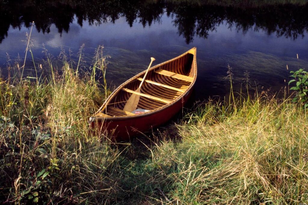 Bill Mason's red canoe sits at the edge of the lake.