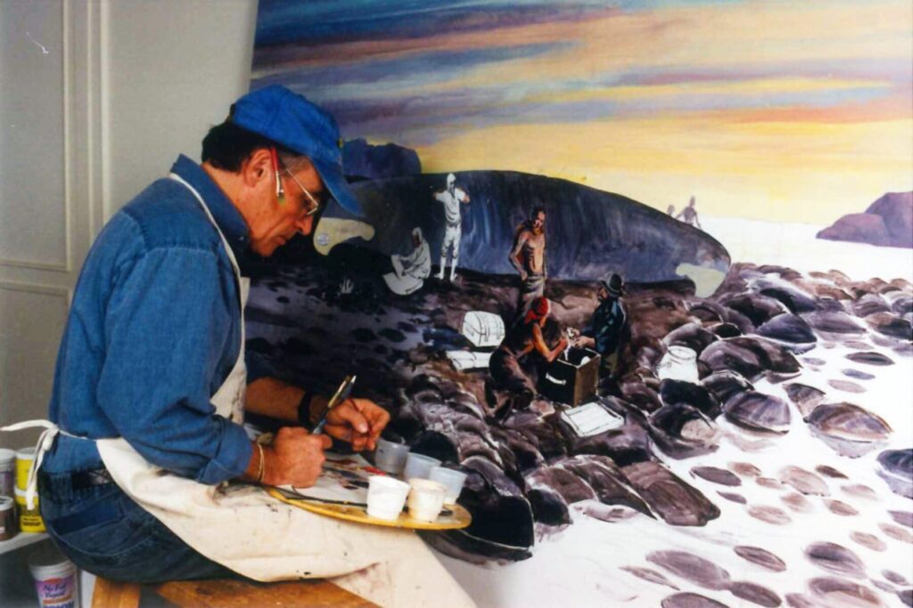 Neil Broadfoot painting a mural at The Canadian Canoe Museum