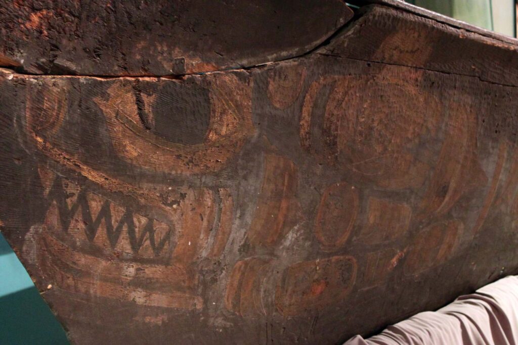 Detailed close up image of the painting details on the bow of a wooden whaling canoe.