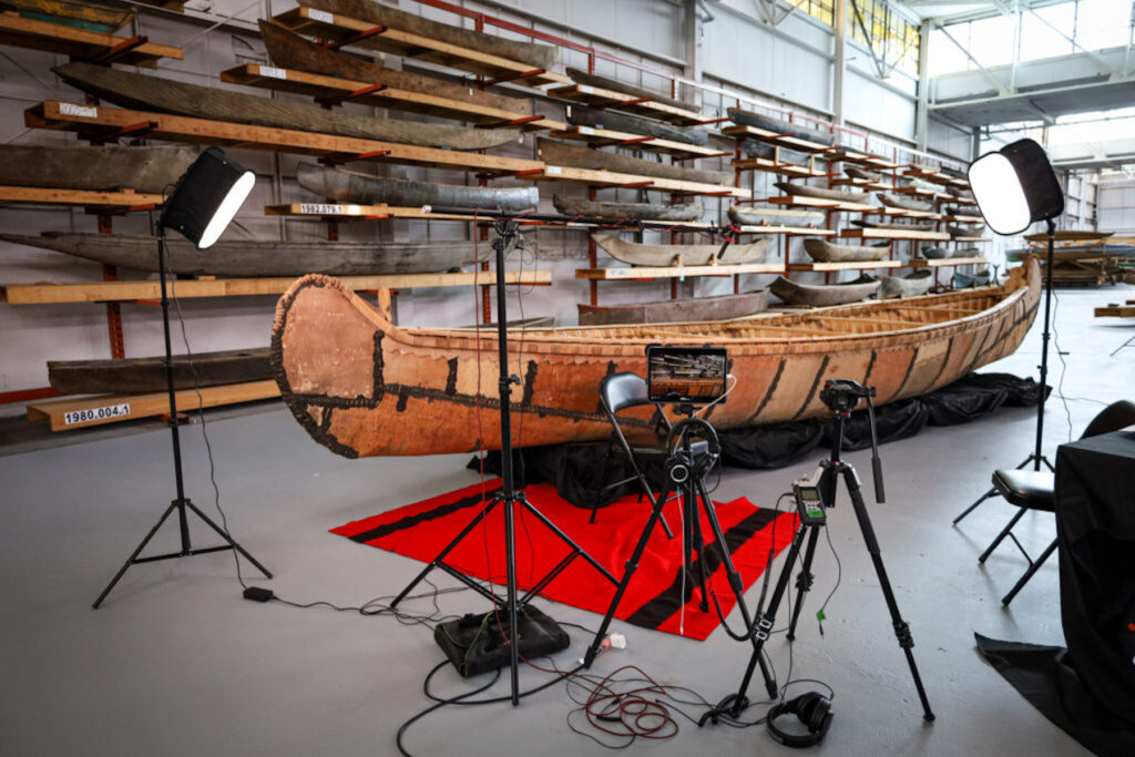 Cameras and lighting setup around a canoe.