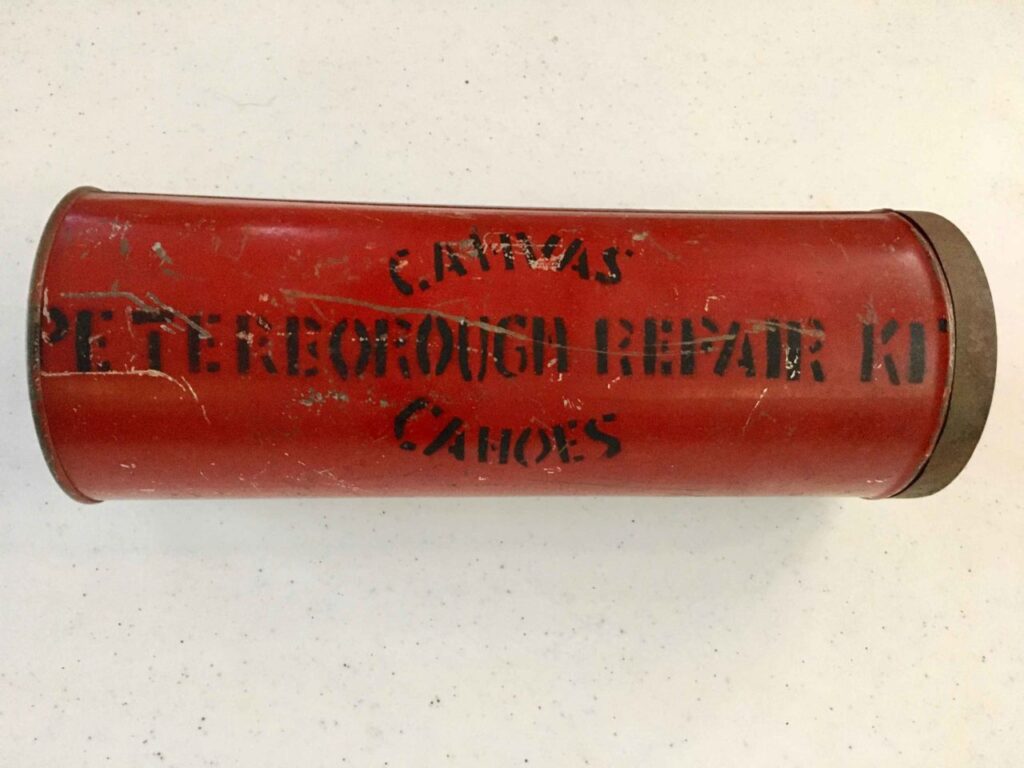 Red antique canoe repair kit canister