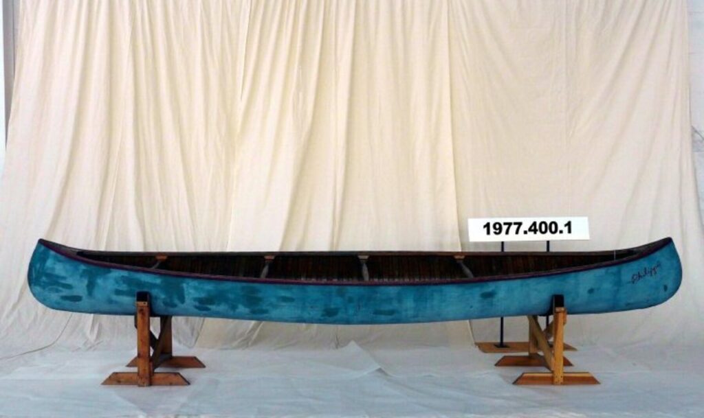 Wood Canvas, Minto Canoe "Phillippe" on display in front of white drop sheet