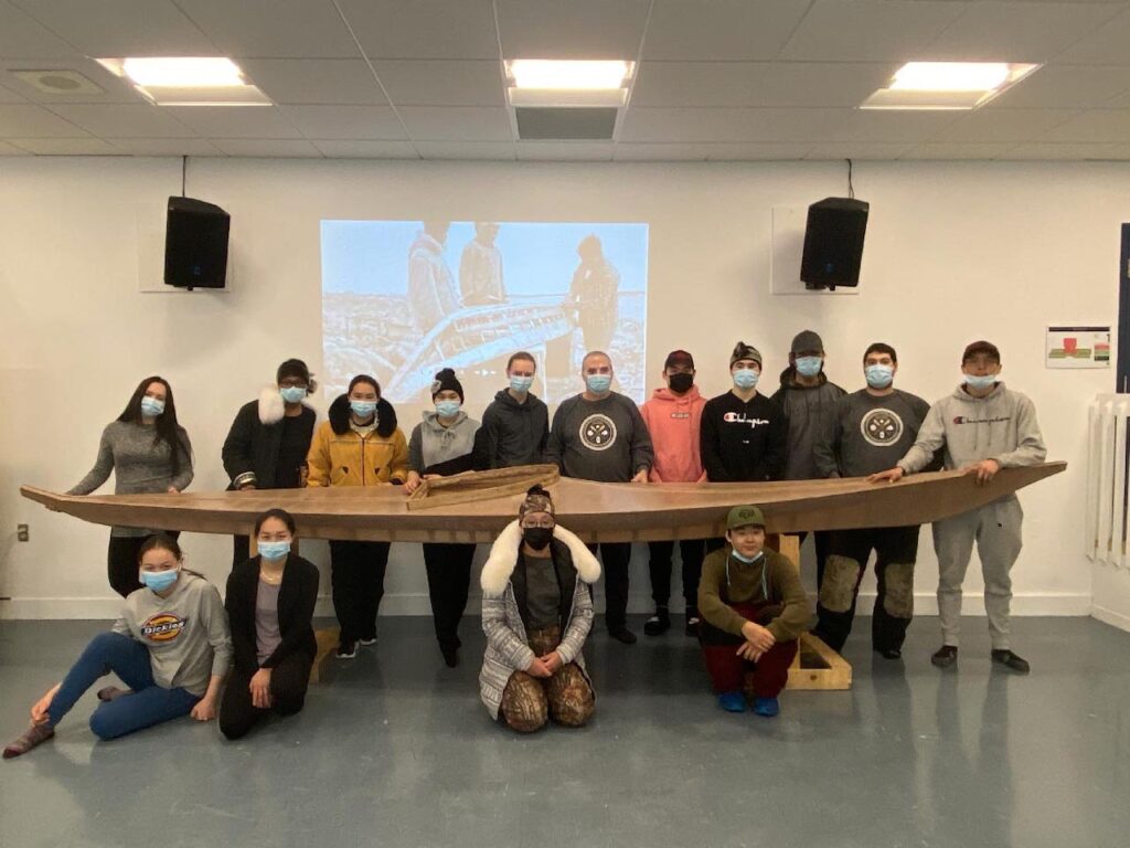 Students from Iquarsivik High School, Puvirnituq, proudly stand with the qajaq (kayak) they built for The Canadian Canoe Museum.