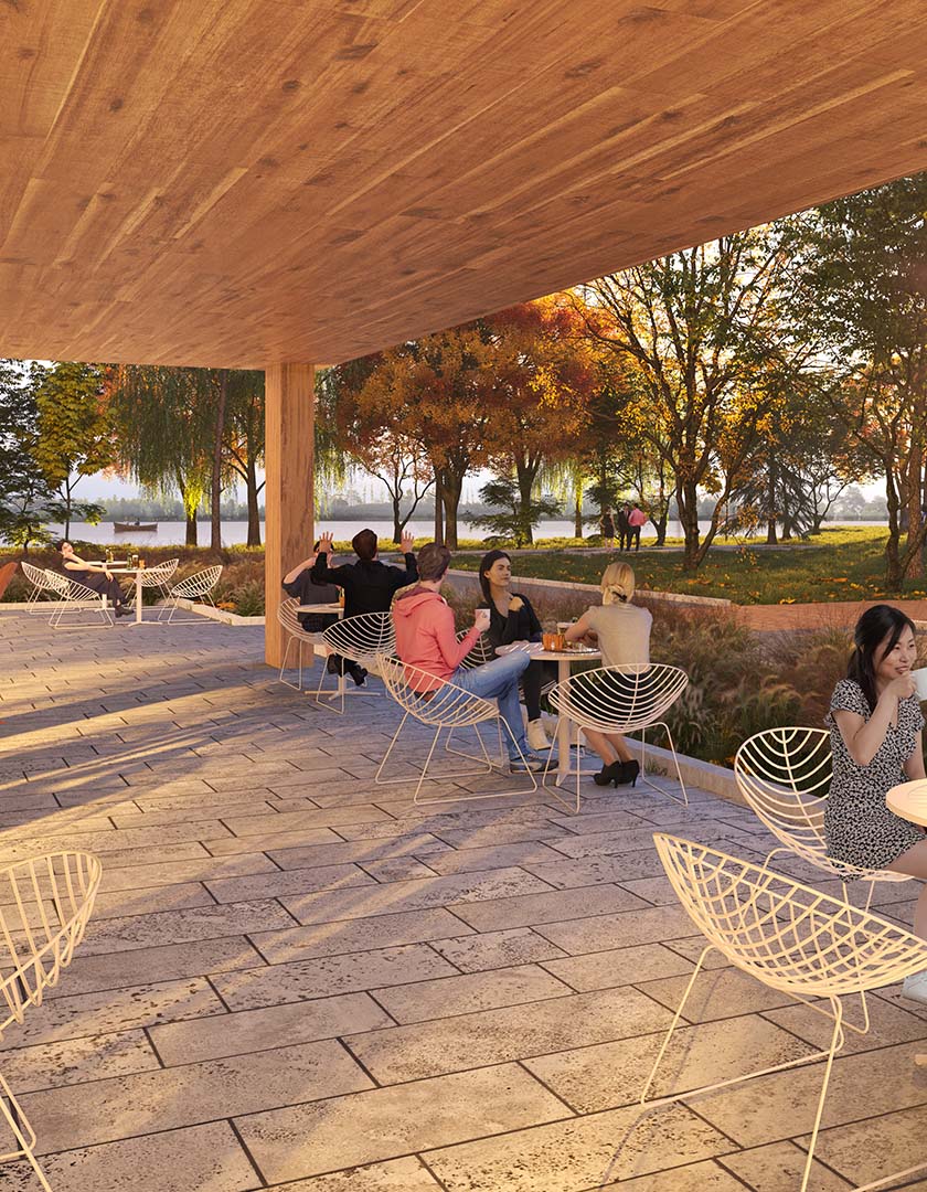 A conceptual render of the outdoor terrace. Visitors sip at their coffee, converse, and enjoy the outdoor fireplace. In the background, visitors are also enjoying the Trans Canada Trail and lakefront.