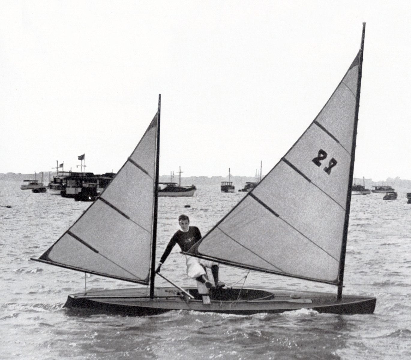 Black and white photo of a canoe with two sails