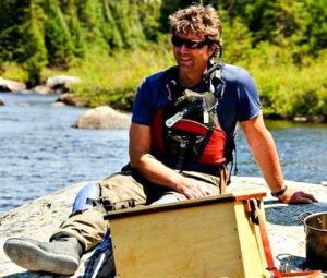 Shawn Hodgins setting on a rock