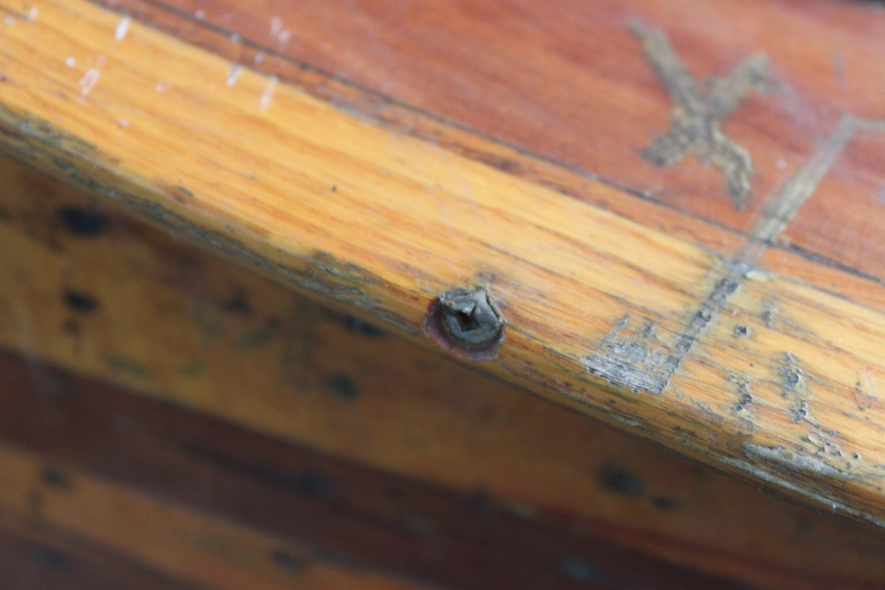 Close up shot of a wooden canoe's gunwale, sometimes referred to as a rail