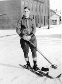 Black and white photograph of Otto Laderach standing on skis and holding ski poles